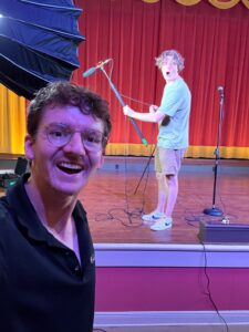 colin onstage with a mic